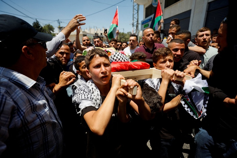 Mourners carry the body of three-year-old Palestinian boy Mohammad al-Tamimi who died of his wounds after being shot by Israeli forces, during his funeral near Ramallah in the Israeli-occupied West Bank June 6, 2023. REUTERS/ Mohammed Torokman