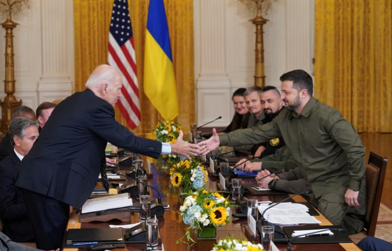 U.S. President Joe Biden and Ukraine President Volodymyr Zelenskiy shake hands across the table during a meeting in the East Room of the White House in Washington, U.S. September 21, 2023. REUTERS/Kevin Lamarque