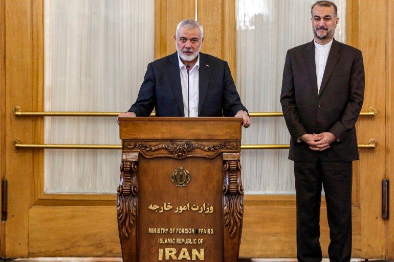 Ismail Haniyeh (L), the Doha-based political bureau chief of the Palestinian Islamist movement Hamas, speaks to the press after a meeting with the Iranian Foreign Minister Hossein Amir-Abdollahian (R) in Tehran on March 26, 2024. - Haniyeh's visit to Tehran comes a day after a resolution adopted by the UN Security Council called for an "immediate ceasefire" for the ongoing Muslim holy month of Ramadan, leading to a "lasting" truce. (Photo by AFP)