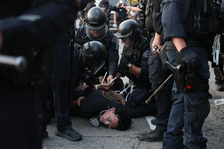 epaselect epa12167302 Police detain a protester as they clash in Los Angeles, California, USA, 09 June 2025. Approximately 2,000 National Guard troops were deployed on 08 June in Los Angeles by US President Donald Trump, though the state of California had not requested any additional assistance, and protests have continued against the Trump administration's immigration enforcement raids over the last couple of days. EPA-EFE/ALLISON DINNER