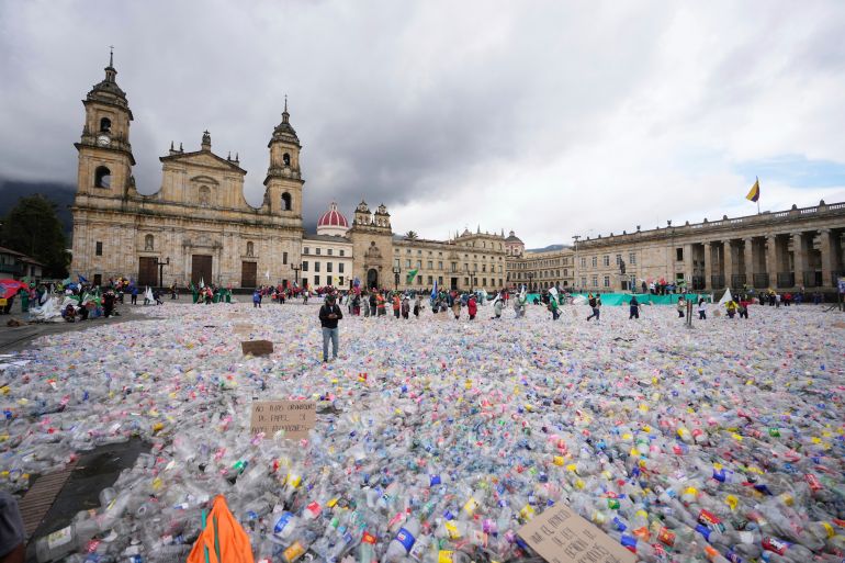Plastic bottles fill Plaza Bolivar in Bogota, Colombia, where they were placed by recyclers protesting what they consider to be too low a price paid to them by companies that buy recycled materials, Tuesday, June 24, 2025. (AP Photo/Fernando Vergara)