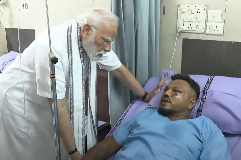 TOPSHOT - This screengrab of video footage taken and released by the Narendra Modi Youtube Channel on June 13, 2025 shows India's Prime Minister Narendra Modi (L) meeting with Vishwash Kumar Ramesh, sole survivor of the Air India flight 171 crash, at a hospital in Ahmedabad.