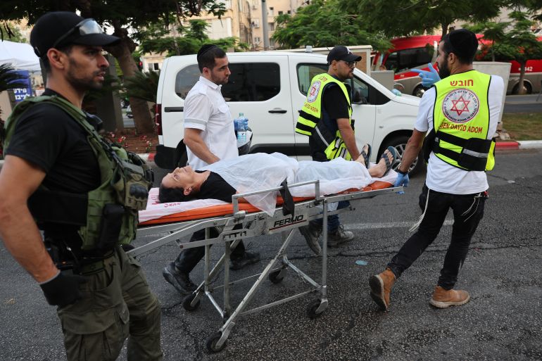 Responders wheel a person on a stretcher following a strike by an Iranian missile in the Israeli city of Bat Yam, south of Tel Aviv, early on June 15, 2025.