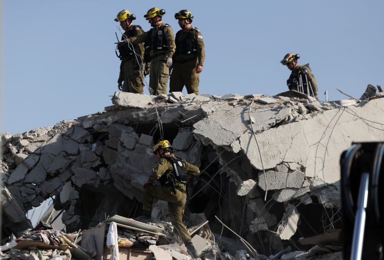 Rescue personnel work at an impact site following missile attack from Iran on Israel, in Rishon LeZion, Israel, June 14, 2025. REUTERS/Ronen Zvulun