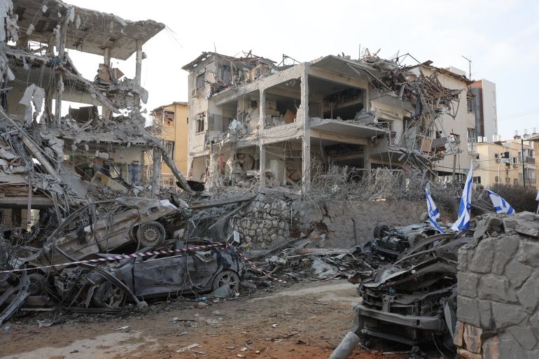 Damaged buildings and vehicles are seen in the Israeli city of Ramat Gan near Tel Aviv on June 14, 2025, caused by the fall of a missile fired the day before by Iran. The UN chief called for Israel and Iran to halt their escalating conflict, after the two countries exchanged a barrage of missiles. (Photo by Jack GUEZ / AFP)