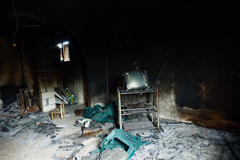 Inside a burned-out house in Al-Qabu. Many Alawite towns and neighborhoods remain all but empty months after the killings, and there's little for their former residents to return to. REUTERS/Stringer