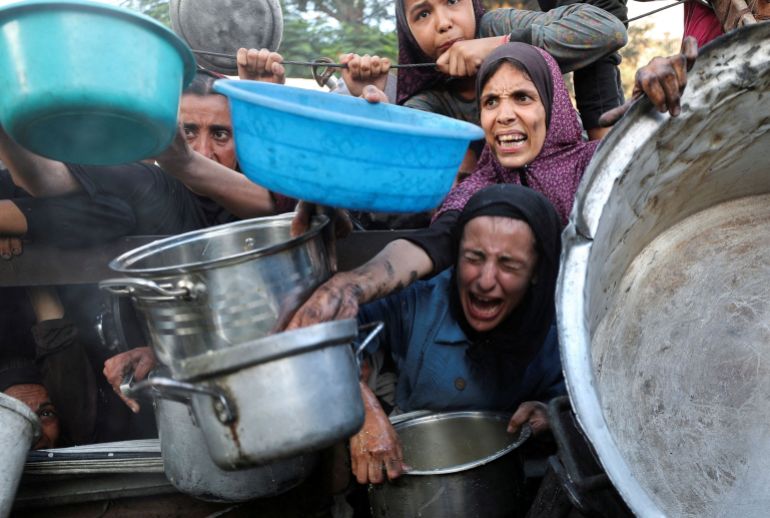 FILE PHOTO: Palestinians wait to receive food from a charity kitchen, amid a hunger crisis, in Gaza City FILE PHOTO: Palestinians react as they ask for food from a charity kitchen, amid a hunger crisis, in Gaza City, July 14, 2025. REUTERS/Mahmoud Issa/File Photo DATE 19/07/2025 SIZE 3500 x 2356 Country PALESTINIAN TERRITORIES SOURCE REUTERS/Mahmoud Issa