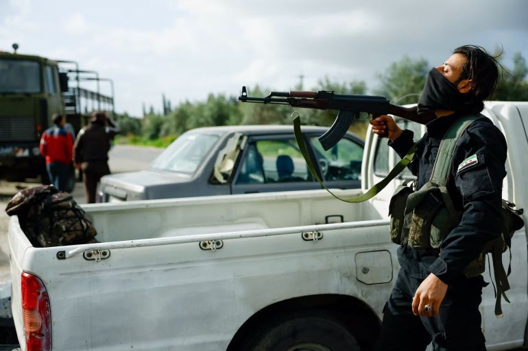 A member of the Syrian security forces at the Hmeimim Air Base. During the killings, bewildered witnesses said some government fighters trying to protect the innocent faced off against uniformed men trying to kill them. REUTERS/Stringer