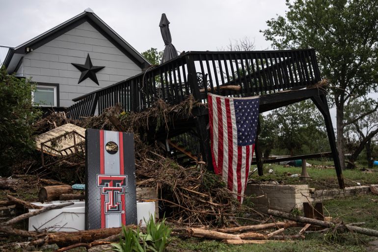 CENTER POINT, TEXAS - JULY 05: A damaged home with debris littered around the exterior sits on the bank Guadalupe River on July 5, 2025 in Center Point, Texas. Heavy rainfall caused flooding along the Guadalupe River in central Texas with multiple fatalities reported. Jim Vondruska/Getty Images/AFP (Photo by Jim Vondruska / GETTY IMAGES NORTH AMERICA / Getty Images via AFP)