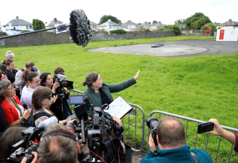 Dr Niamh McCullagh, senior forensic consultant, points to the excavation site, Tuam, Ireland, Monday July 7, 2025 as workers have begun moving into the site ahead of the excavation at St Mary's home for unmarried mothers and their children which was run by the Bon Secours Sisters, the Catholic nuns based in Tuam. (AP Photo/Peter Morrison)
