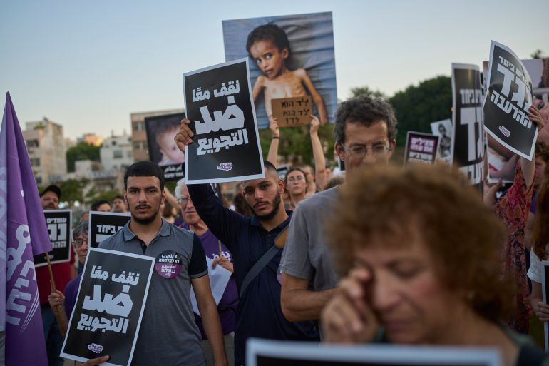 Israeli activists take part in a protest against the war in the Gaza Strip, Israel's measures regarding food distribution and the forced displacement of Palestinians, in Tel Aviv, Israel, Tuesday, July 22, 2025. (AP Photo/Ohad Zwigenberg)