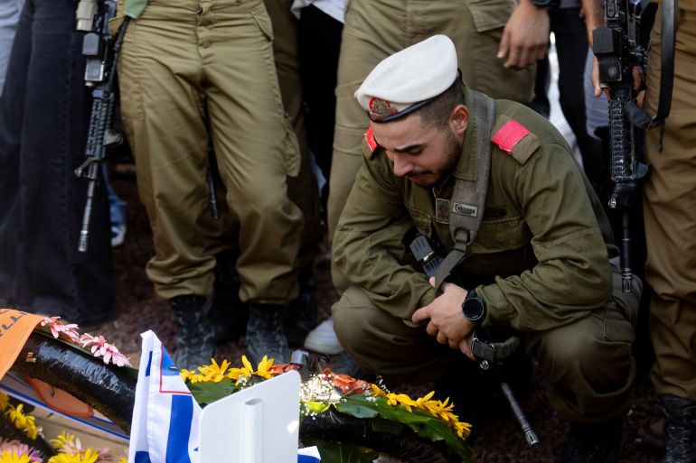 ELYAKHIN, ISRAEL - JUNE 25: An Israeli soldier mourns during a funeral for IDF Staff Sgt. Niv Radia on June 25, 2025 in Elyakhin, Israel. Radia was one of seven Israeli soldiers in the 605th Combat Engineering Battalion who were killed yesterday in Gaza. (Photo by Amir Levy/Getty Images)