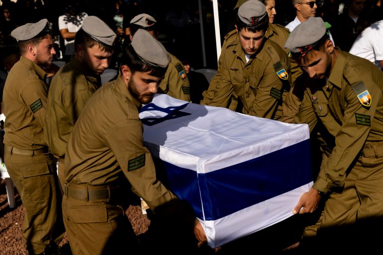 ELYAKHIN, ISRAEL - JUNE 25: Israeli soldiers carry a coffin during a funeral for IDF Staff Sgt. Niv Radia on June 25, 2025 in Elyakhin, Israel. Radia was one of seven Israeli soldiers in the 605th Combat Engineering Battalion who were killed yesterday in Gaza. (Photo by Amir Levy/Getty Images)
