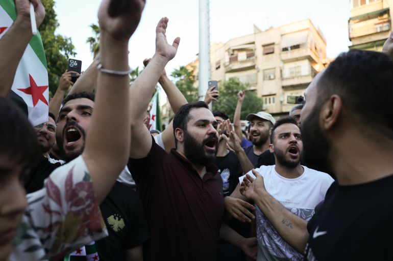 DAMASCUS, SYRIA - JULY 16: Demonstrators react during a rally against Israeli intervention in Syria on July 16, 2025 in Damascus, Syria. A rally was held in Damascus in support of Syria's interim government and to denounce Israel's intervention following recent clashes between Syrian government forces and Druze militia in the southern Syrian city of Sweida, or Suwayda. A spokesperson from the Israeli Defense Forces (IDF) confirmed Wednesday that Israeli airstrikes targeted the headquarters of Syria's defence ministry and a site near the presidential palace in Damascus. (Photo by Ali Haj Suleiman/Getty Images)