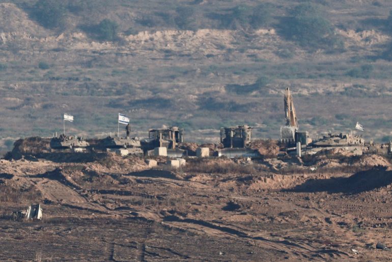 FILE PHOTO: Israeli soldiers and military vehicles operate in Gaza, as seen from the Israeli side of the Israel-Gaza border, July 7, 2025. REUTERS/Amir Cohen/File Photo