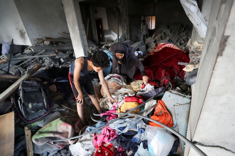 Palestinians inspect the site of Thursday's Israeli strike that damaged and destroyed residential buildings, at Shati (Beach) refugee camp, in Gaza City, July 4, 2025. REUTERS/Mahmoud Issa