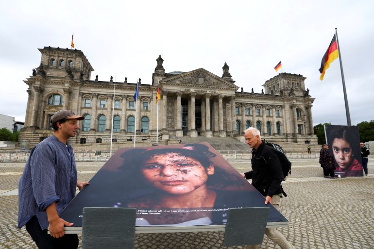 Activists move a picture, shot by Reuters photographer Mohammed Jadallah Salem, showing a child from Gaza in front of the Reichstag building, during a protest calling for more commitment of the German government to the children of Gaza and the defense of international law, in Berlin, Germany, July 9, 2025. REUTERS/Lisi Niesner TPX IMAGES OF THE DAY