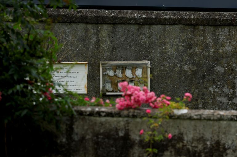 A memorial of baby socks in a frame is put up at the Tuam graveyard, where the bodies of 796 babies were uncovered at the site of a former Catholic Church-run Bon Secours Mother and Baby Home, in Tuam, Ireland, July 7, 2025. REUTERS/Clodagh Kilcoyne