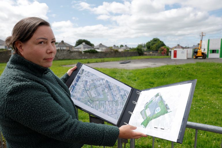 Senior Forensic Consultant Niamh McCullagh shows a map of the planned excavation of the Tuam graveyard, where the bodies of 796 babies were uncovered at the site of a former Catholic Church-run Bon Secours Mother and Baby Home, near the excavation site in Tuam, Ireland, July 7, 2025. REUTERS/Clodagh Kilcoyne