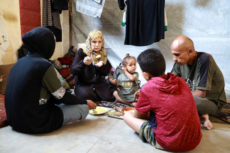 Fatima Arafa, a pregnant and displaced Palestinian woman, eats a meal inside her tent, where she has taken shelter with her family after fleeing their home, in Gaza City, July 10, 2025. REUTERS/Ebrahim Hajjaj