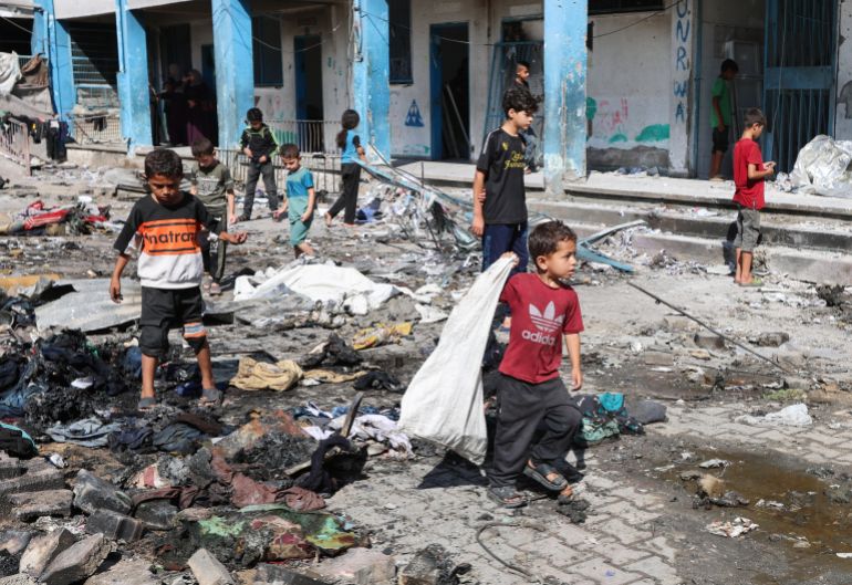 Palestinian children walk, near the site of an overnight Israeli strike on a school sheltering displaced people, in Bureij refugee camp, in the central Gaza Strip, July 8, 2025. REUTERS/Ramadan Abed