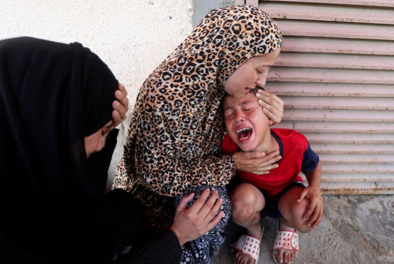 Palestinian mother Samah Al-Nouri, whose daughter Sama was killed in an Israeli strike on Thursday near a medical center in Deir Al-Balah, comforts her son, as casualties from the strike are brought into Al-Aqsa Martyrs Hospital, in Deir al-Balah, central Gaza Strip, July 10, 2025. REUTERS/Ramadan Abed TPX IMAGES OF THE DAY