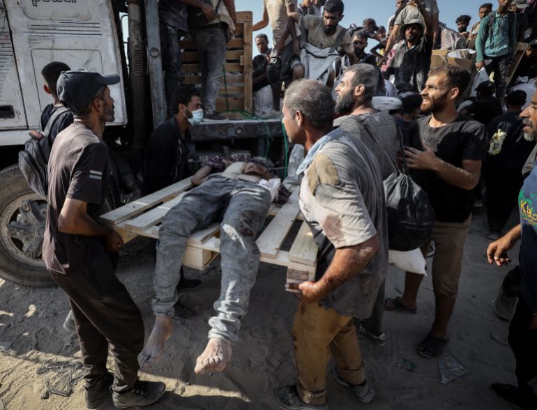GAZA CITY, GAZA - AUGUST 2: (EDITORS NOTE: Image depicts death) Palestinians carry the bodies after the Israeli forces opened fire on Palestinians waiting for humanitarian aid in the northern Gaza area of Zikim Crossing in Gaza City, Gaza on August 2, 2025. Survivors and witnesses rushed to evacuate the wounded and the dead from the area. ( Khames Alrefi - Anadolu Agency )