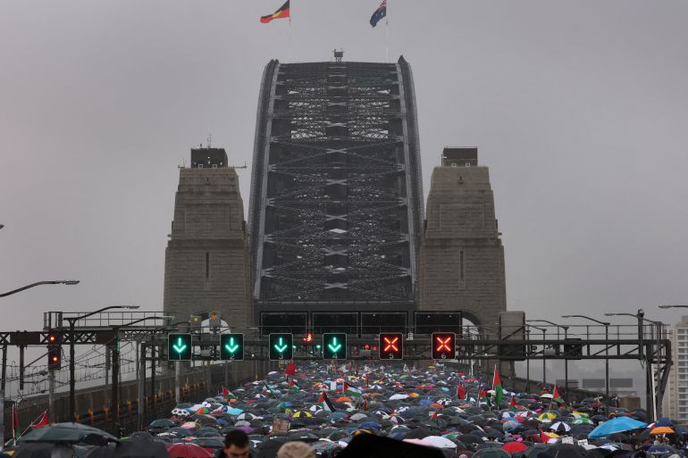 Demonstrators march across the Sydney Harbour Bridge during a pro-Palestinian rally against Israel's actions and the ongoing food shortages in the Gaza Strip, in Sydney on August 3, 2025. (Photo by DAVID GRAY / AFP)