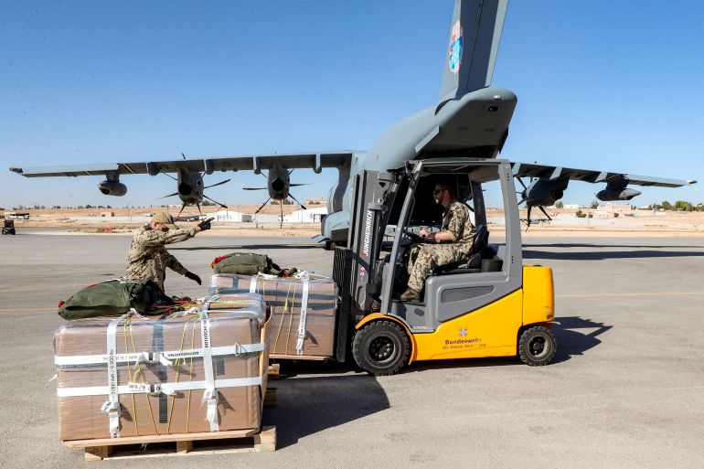 A German Air Force (Luftwaffe) airman uses a forklift to load a humanitarian aid pallet into the cargo bay of an A400M Atlas military transport aircraft on the tarmac at King Abdullah II airbase in Zarqa, Jordan, on August 5, 2025, before taking off for a humanitarian aid airdrop mission over the Gaza Strip.