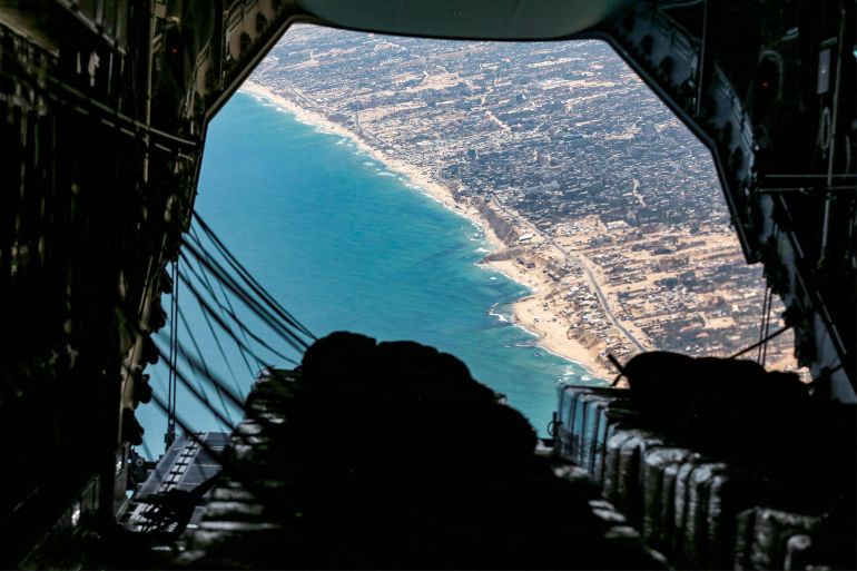 The cargo ramp of a German Air Force (Luftwaffe) A400M Atlas military transport aircraft is opened before releasing humanitarian aid pallets during an airdrop relief mission over the Gaza Strip on August 5, 2025.