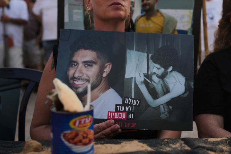 A woman holds a photo of Israeli hostage Evyatar David, showing him before and during his captivity in the Gaza Strip, at a rally calling for the release of all hostages held by Hamas and an end to the ongoing war, in Tel Aviv, Israel, Saturday, Aug. 9, 2025. (AP Photo/Ohad Zwigenberg)