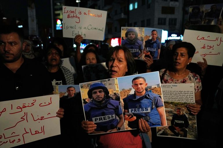 Protesters chant anti Israel slogans and carry posters with pictures of Palestinian journalists Anas al-Sharif and Mohamed Qreiqeh that Israel's military targeted and killed with an airstrike late Sunday in Gaza, during a protest in the West Bank city of Ramallah Monday, Aug. 11, 2025. (AP Photo/Nasser Nasser)