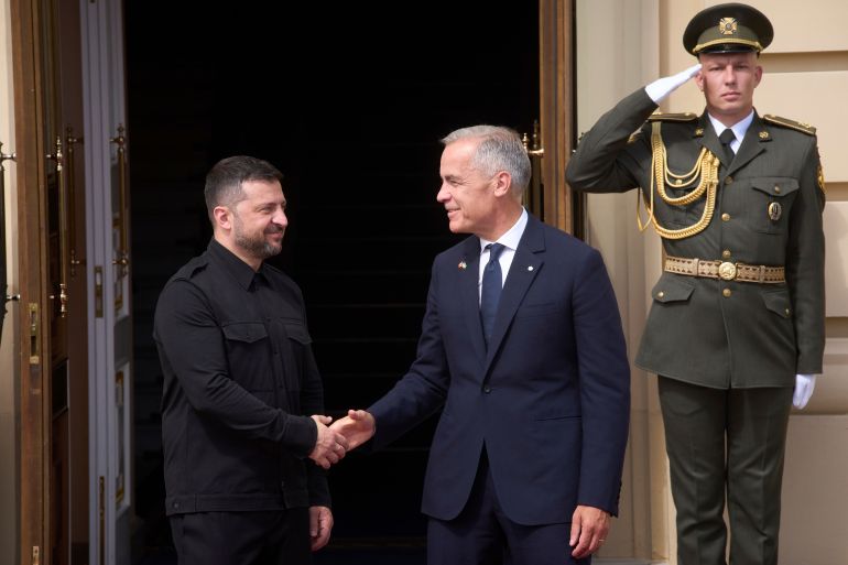 Canadian Prime Minister Mark Carney, right, shakes hands with Ukrainian President Volodymyr Zelenskyy during their meeting in Kyiv, Ukraine, Sunday, Aug. 24, 2025. (AP Photo/Efrem Lukatsky)