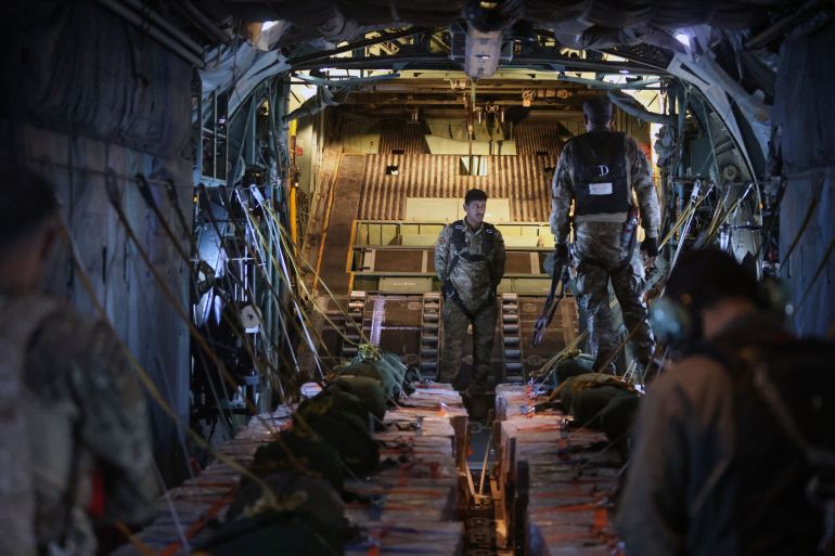 GAZA - AUGUST 6: Jordanian air force personnel in a Jordanian C-130 military aircraft prepare to perform an air drop of aid and humanitarian supplies on August 6, 2025 in Gaza. On Wednesday, the Royal Jordanian Air Force carried out air drops of food and other aid over Gaza, alongside aircraft from other nations carrying 54 tons of humanitarian supplies. Airdrops of aid have resumed in recent weeks in an attempt to alleviate the severe lack of food and other essentials reaching people in Gaza, where the World Food Programme (WFP) has said over half a million people are enduring famine-like conditions, as Israel continues to restrict the flow of aid. (Photo by Salah Malkawi/Getty Images)