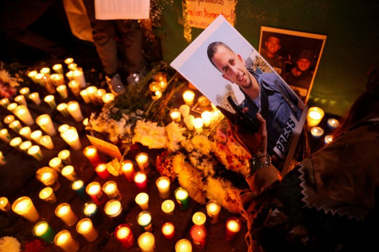 A demonstrator holds a photo of Al Jazeera Arabic correspondent Anas al-Sharif, who was killed along with his colleagues during an Israeli airstrike in Gaza on Sunday, amid the ongoing conflict between Israel and Hamas, at the Angel of Independence monument in Mexico City, Mexico, August 12, 2025. REUTERS/Luis Cortes TPX IMAGES OF THE DAY
