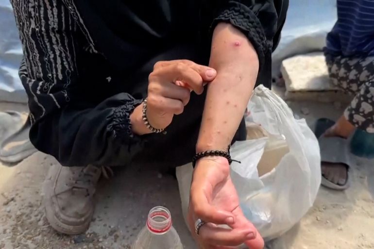 PALESTINIANS GATHERING AT A SOUP KITCHEN IN GAZA CITY TO GET FOOD / PALESTINIAN MOTHER OF THREE, HEBA AL-GHAMARI, TALKING ABOUT DAILY STRUGGLE TO GET FOOD