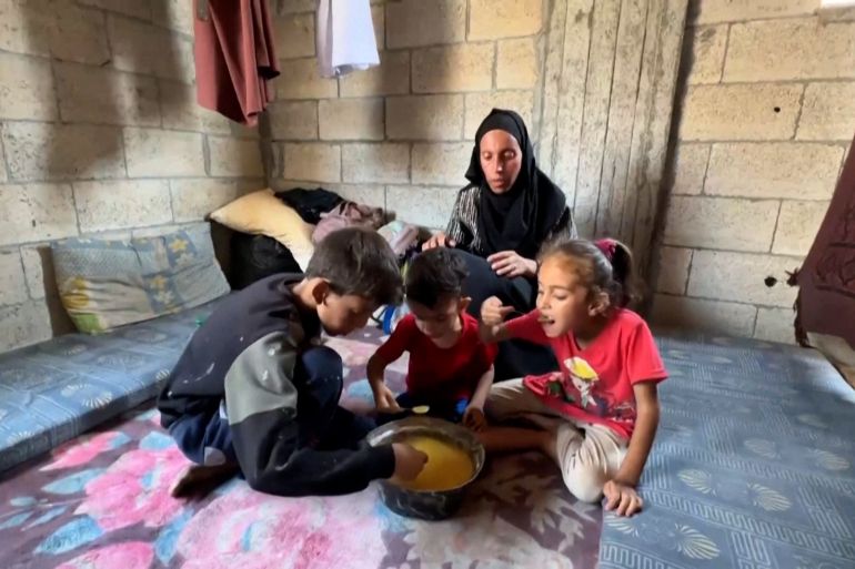 دPALESTINIANS GATHERING AT A SOUP KITCHEN IN GAZA CITY TO GET FOOD / PALESTINIAN MOTHER OF THREE, HEBA AL-GHAMARI, TALKING ABOUT DAILY STRUGGLE TO GET FOOD