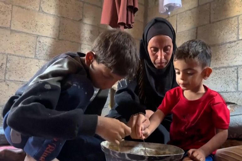 PALESTINIANS GATHERING AT A SOUP KITCHEN IN GAZA CITY TO GET FOOD / PALESTINIAN MOTHER OF THREE, HEBA AL-GHAMARI, TALKING ABOUT DAILY STRUGGLE TO GET FOOD
