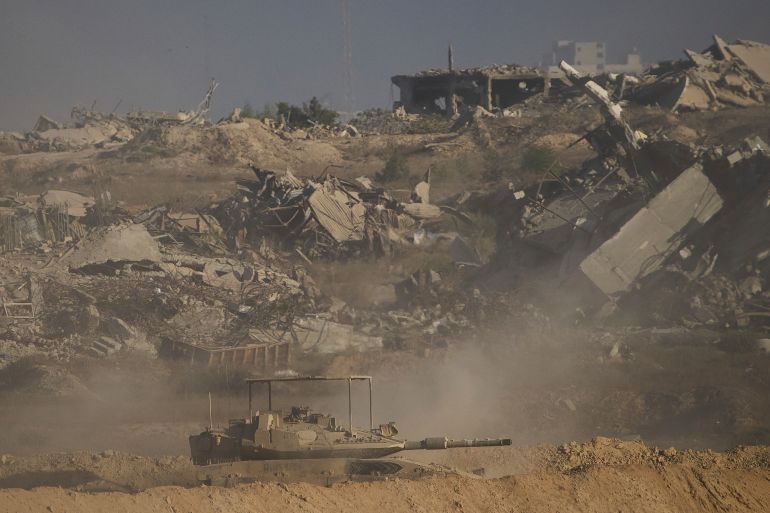 Israeli soldiers drive a tank inside the Gaza Strip as seen from southern Israel, Wednesday, Sept. 3, 2025. (AP Photo/Ariel Schalit)