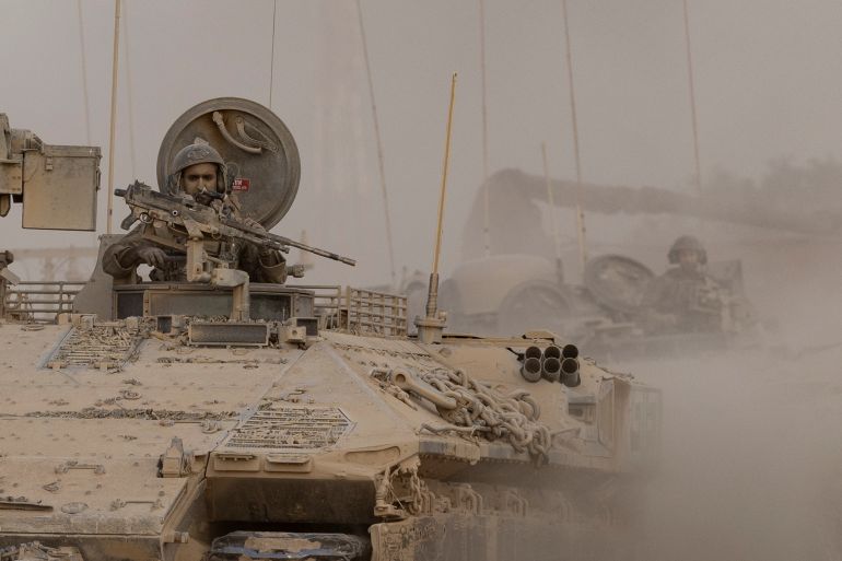 SOUTHERN ISRAEL, ISRAEL - SEPTEMBER 7: Israeli soldiers holds a machine gun as he is standing on an armored personnel carrier near the border with the Gaza Strip on September 7, 2025 in Southern Israel, Israel. The Israel Defence Force are in control of over 40% of Gaza City after mounting a new offensive, leveling buildings in the neighborhood. Prime Minister Netanyahu announced Israel's intention to seize all of the strip after peace talks with Hamas broke down in July. (Photo by Amir Levy/Getty Images)