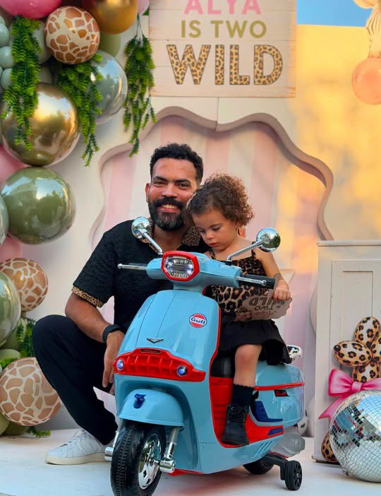 May be an image of baby, motorcycle, scooter and text