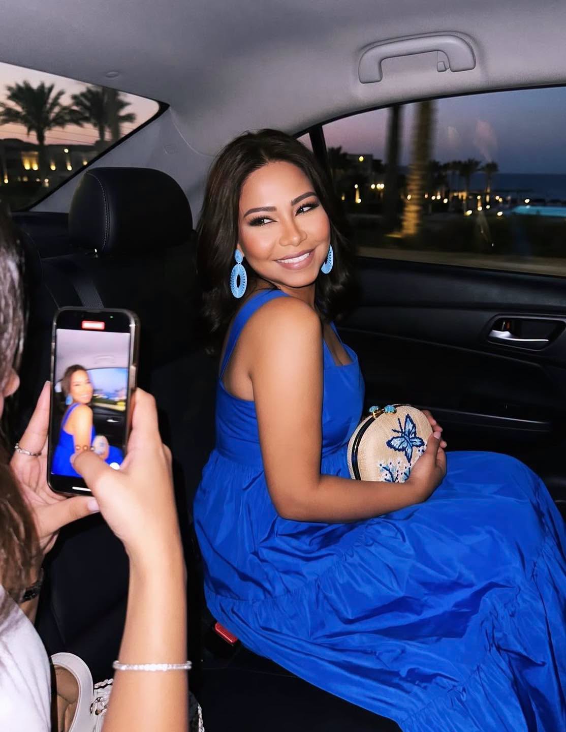 May be an image of one or more people, people smiling and rear-view mirror